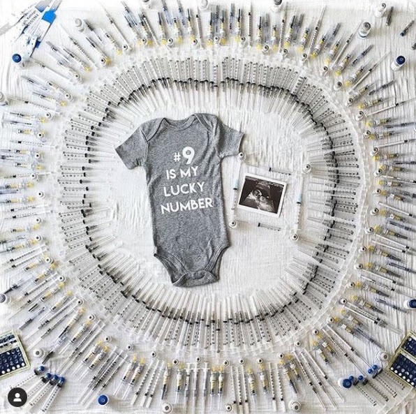 IVF Pregnancy announcement with needles and #9 onesie