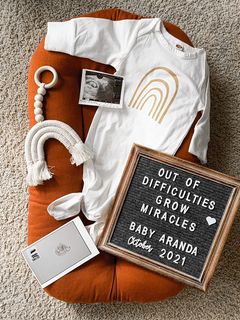 IVF Pregnancy announcement with rainbow onesie