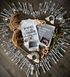 IVF pregnancy announcement with needles in a heart shape