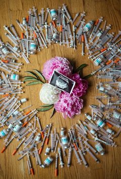 IVF Pregnancy announcement with needles and flowers